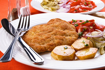 Fried chop pork with potatoes and vegetable salad