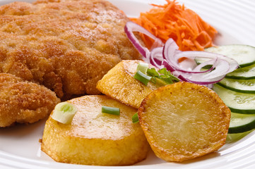 Fried chop pork with potatoes and vegetable salad