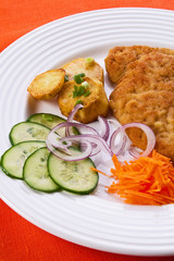 Fried chop pork with potatoes and vegetable salad