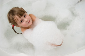 young girl in foam bath