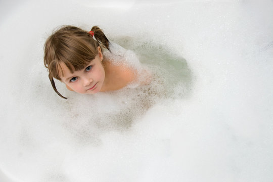 young girl in foam bath
