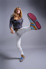 young beautiful dancer posing on grey