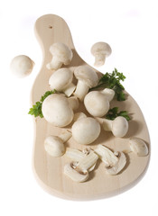 Edible mushrooms on wooden chopping board