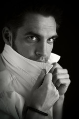 young man in a white shirt on a black background