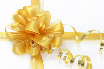golden bow with a curly ribbon on a white background