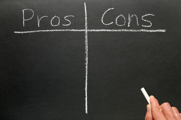 Writing the pros and cons on a blackboard.