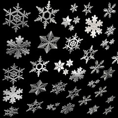Flying silver snow flakes on black background