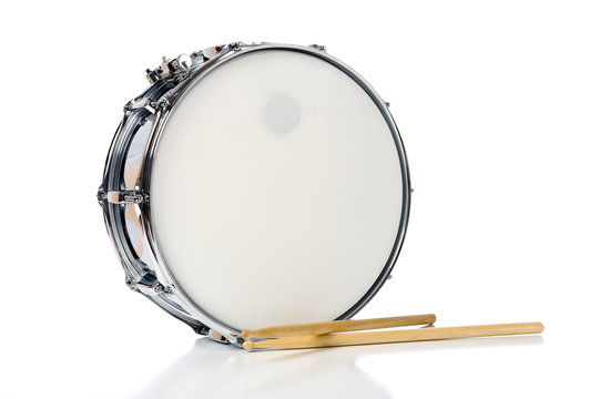 A new silver snare drum with sticks on a white background