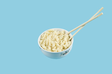 Bowl with rice and chopsticks