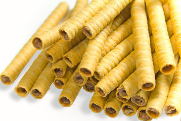 heap of striped wafer tubules with chocolate cream