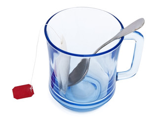 Blue cup with tea bag and spoon in it