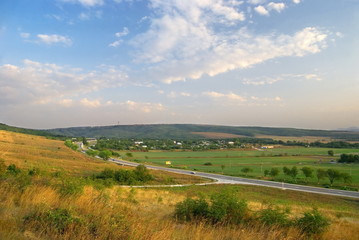 Obraz premium Autumn landscape. A meadow, hills and road