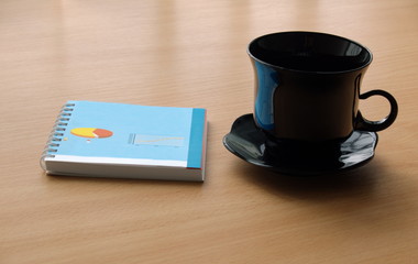 cup and notepad in ofice