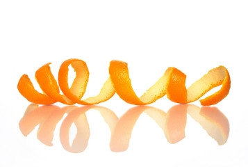 Spiral orange peel reflecting on white background.