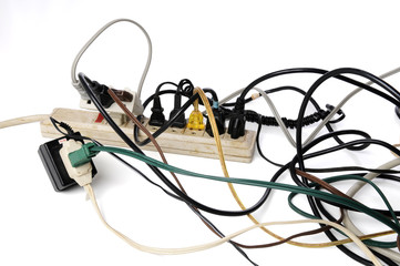 Dirty old power strip overloaded with too many cords