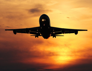 airliner landing at sunset, closeup