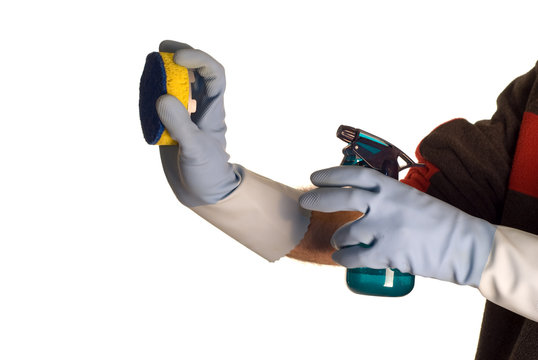 A man holding a squit bottle and a scrubber