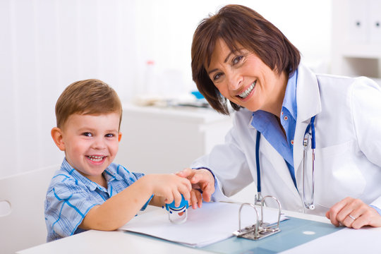 Senior female  pediatrician playing with child