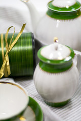 white with green tea service and gift box on napkin