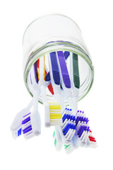 Toothbrushes in Glass Jar on White Background
