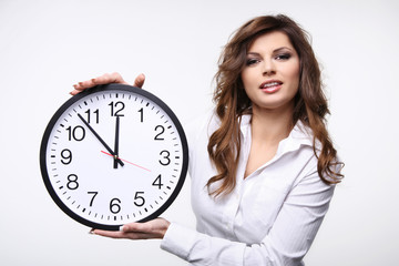 Beautiful smiling woman holding big clock.