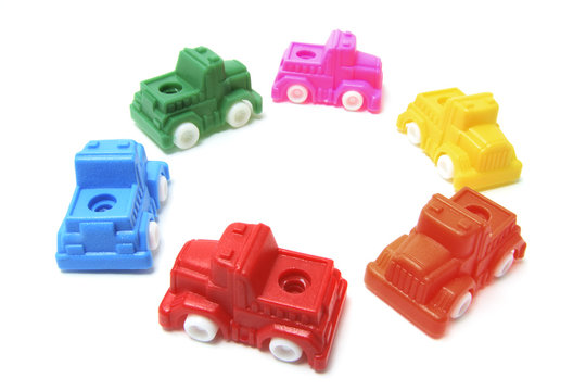 Plastic Toy Cars Arranged in Circle on White Background