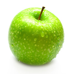 The ripe juicy apple covered by drops of water. Isolation
