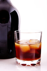 bottle and glass of cotch whisky on a white background