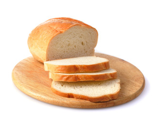 loaf witn cut slices of bread on wood kitchen plate