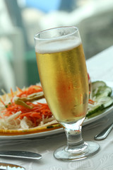 bowl of salad and glass beer