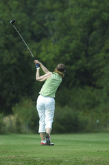 Woman golfer doing a swing
