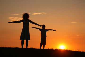 Fototapeta premium Mother and son on sunset stretching