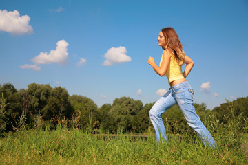 Fototapeta premium Young girl runs in park