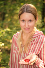 Girl with wood berries on palm