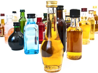 different alcohol bottles against the white background