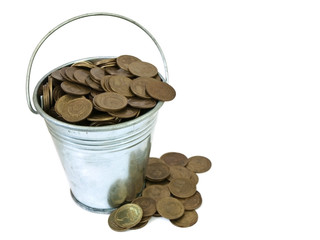 turned over bucket with coins on a white background
