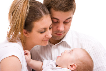 Happy family - father, mother and their cute little baby