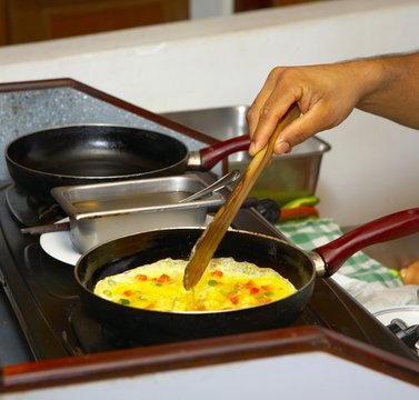 Chef Is Cooking Omelet With Tomato