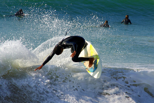 Photo of surfer riding a wave in a beach