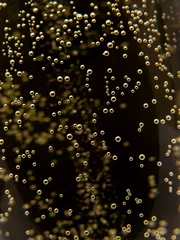 Foto op Canvas Macro of sparkling champagne against black background. © StockPhotosArt