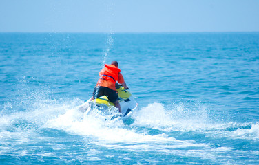 Man driving a motorised scooter at sea