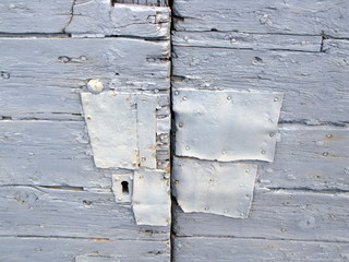 Vieille porte grise réparée.