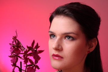 Fototapeta premium Young fashion model in studio with orchid