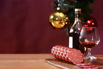 cognac, glass and sausage on a New Year's background