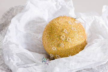 holiday series: golden Christmas ball on the white paper
