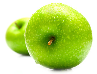 ripe juicy green apples covered by drops of water. Isolation