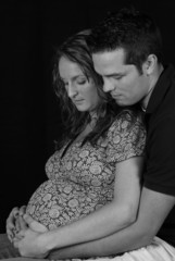 B&W of mother and father to be sitting together .