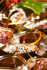 Assorted chocolate candy in a box with Christmas decoration