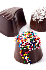 Assorted chocolate candy over white nackground..