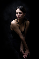 young elegant woman, studio dark background